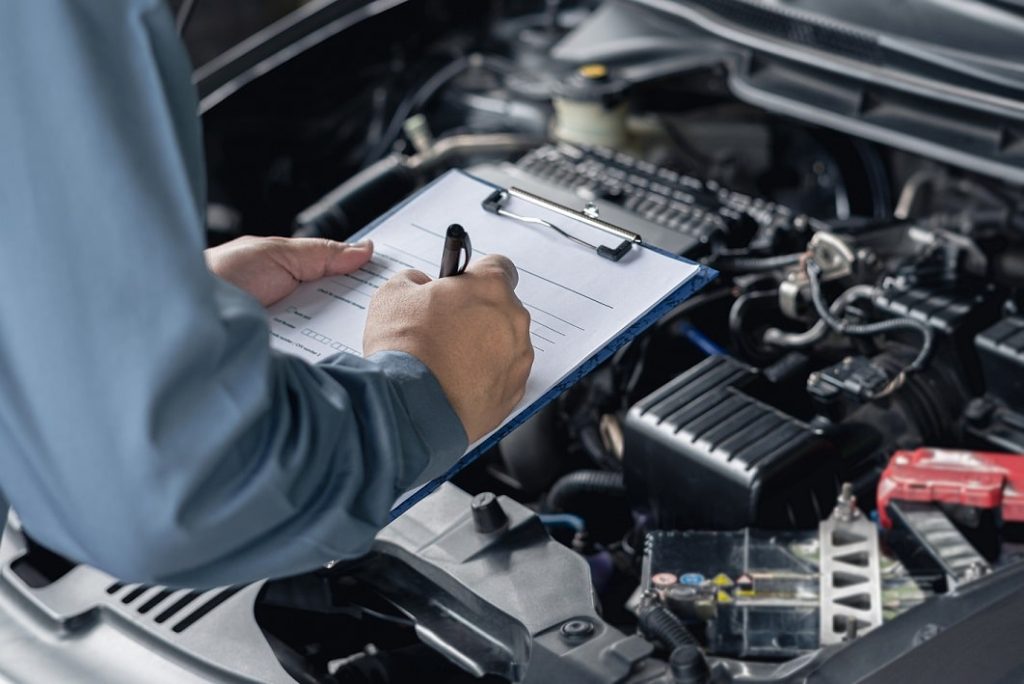 Technicians repairing cars with futuristic tools